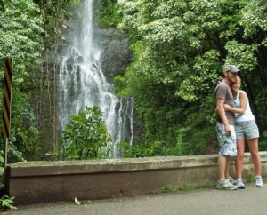 a person standing next to a waterfall