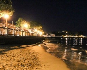 a body of water with a city in the night sky