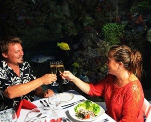 a group of people sitting at a table with a plate of food